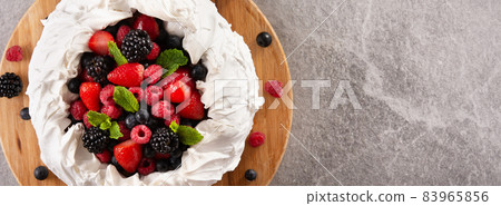 Delicious Pavlova cake with meringue topped and fresh berries Delicious Pavlova cake with meringue topped and fresh berries 83965856