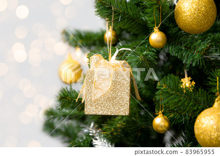 Christmas Tree with golden gift box and ornament on blurred light background, Holidays Concepts Christmas Tree with golden gift box and ornament on blurred light background, Holidays Concepts 83965955
