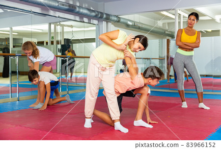 Kids in pair exercising self-defense movements Kids in pair exercising self-defense movements 83966152
