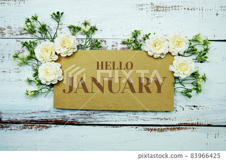 Hello January typography text decorate with flower on wooden background 83966425