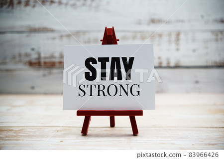 Stay Strong text on paper card with wooden background 83966426