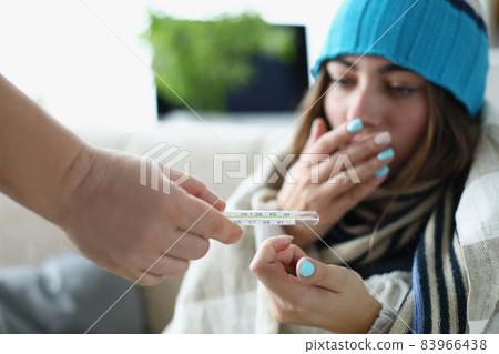 Woman coughing with high temperature symptoms of coronavirus disease 83966438