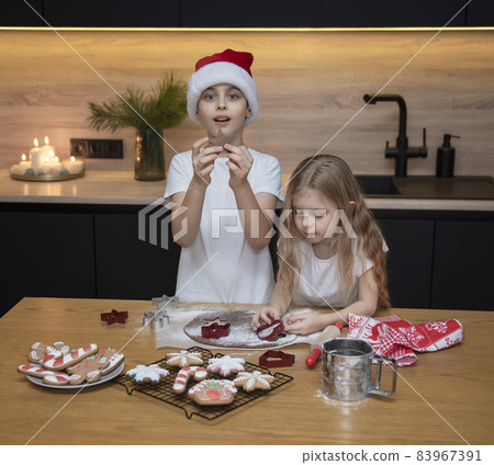 Children - a boy and a girl are preparing gingerbread in the kitchen 83967391