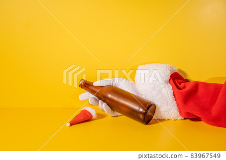Santa Claus holding beer bottle with his hands Santa Claus holding beer bottle with his hands 83967549