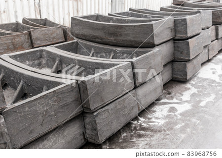 Cast iron tubing reinforced concrete cast products for lining distillation tunnels and underground structures are stored in the warehouse of the industrial plant Cast iron tubing reinforced concrete cast products for lining distillation tunnels and underground structures are stored in the warehouse of the industrial plant 83968756
