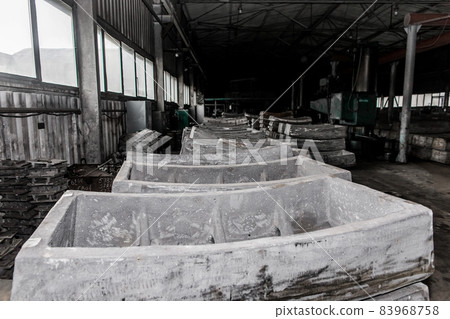 Cast iron tubing reinforced concrete cast products for lining distillation tunnels and underground structures are stored in the warehouse of the industrial plant Cast iron tubing reinforced concrete cast products for lining distillation tunnels and underground structures are stored in the warehouse of the industrial plant 83968758