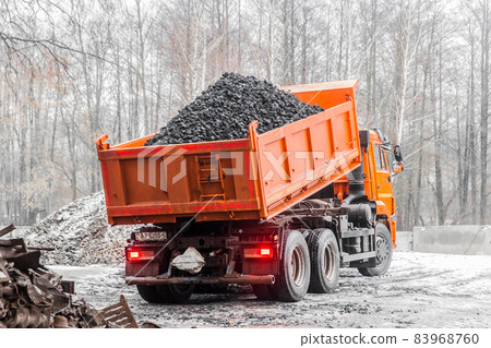 Dump truck in the industrial zone unloads coking coal from the body 83968760