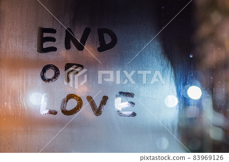 the words end of love handwritten on night wet window glass the words end of love handwritten on night wet window glass 83969126