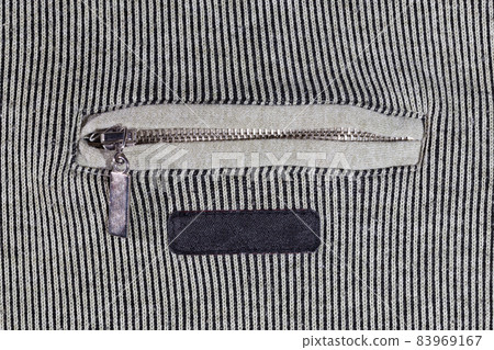abstract vertical striped texture of flat fabric surface with zip locking chest pocket, and black blank label abstract vertical striped texture of flat fabric surface with zip locking chest pocket, and black blank label 83969167