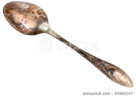 German silver or cupronickel spoon with visible oxidation layer isolated on white baclground German silver or cupronickel spoon with visible oxidation layer isolated on white baclground 83969247
