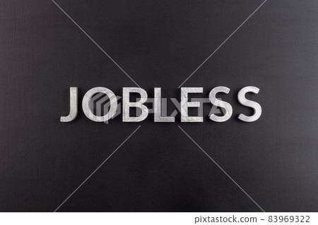 the word jobless laid with white scratched metal letters on flat black surface the word jobless laid with white scratched metal letters on flat black surface 83969322