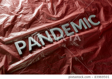 the word pandemic laid with silver letters on crumpled orange plastic film - diagonal perspective composition with selective focus the word pandemic laid with silver letters on crumpled orange plastic film - diagonal perspective composition with selective focus 83969501