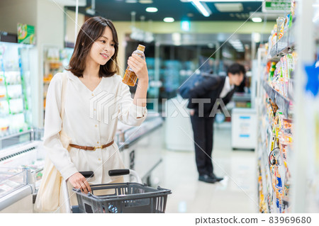 Young housewife shopping for groceries at a supermarket Young housewife shopping for groceries at a supermarket 83969680