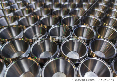 A batch of shiny steel parts. Regular industrial metal production pattern with selective focus. 83969875