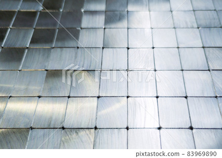 shiny steel machined blocks pavement surface background - close-up with selective focus and blur 83969890