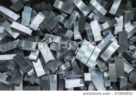 a pile of shiny faceted steel blocks - full frame close-up with selective focus 83969892