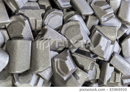 heap of gray steel forgings after shot blasting - close-up natural heavy industrial pattern with selective focus 83969930