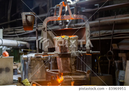 small metallurgical ladle with molten steel moves on a hook of crane small metallurgical ladle with molten steel moves on a hook of crane 83969951