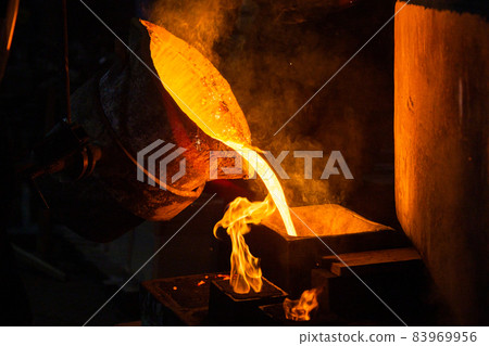 Close-up view of industrial chill casting. The process of for filling out mold with molten metal. Close-up view of industrial chill casting. The process of for filling out mold with molten metal. 83969956