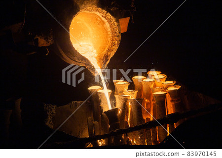 Industrial lost wax casting. The process of pouring for filling out ceramic shells with molten steel. Industrial lost wax casting. The process of pouring for filling out ceramic shells with molten steel. 83970145