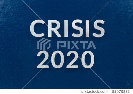 the words crisis 2020 laid with silver metal letters on blue surface for stock market background the words crisis 2020 laid with silver metal letters on blue surface for stock market background 83970281