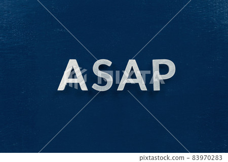 The word asap laid with silver metal letters in center of painted classic blue flat board. View in flat lay perspective. The word asap laid with silver metal letters in center of painted classic blue flat board. View in flat lay perspective. 83970283