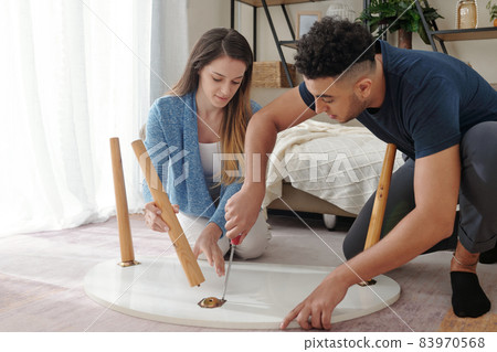 Couple Assembling Coffee Table Couple Assembling Coffee Table 83970568