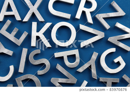 Abstract flat background of silver metal english alphabet characters on classic blue background. Abstract flat background of silver metal english alphabet characters on classic blue background. 83970876