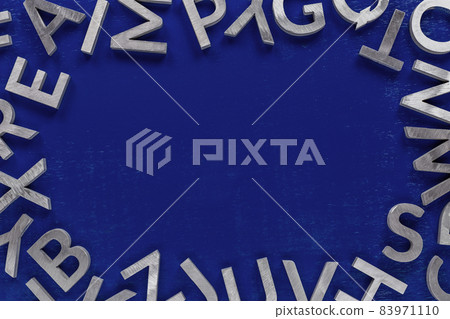 Frame mockup made of of silver metal english alphabet characters on blue background. Frame mockup made of of silver metal english alphabet characters on blue background. 83971110