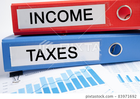 Income and Taxes. Binder data finance report business with graph analysis in office. Income and Taxes. Binder data finance report business with graph analysis in office. 83971692
