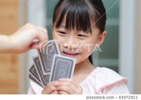 Girl playing cards to maid 83972921