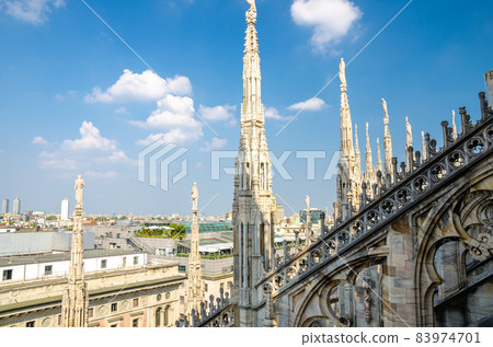 White marble statues on roof of Duomo di Milano Cathedral, Italy White marble statues on roof of Duomo di Milano Cathedral, Italy 83974701