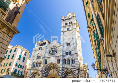 Facade of San Lorenzo Cathedral catholic church on Piazza San Lorenzo square among buildings in historical centre of old european city Genoa 83974743