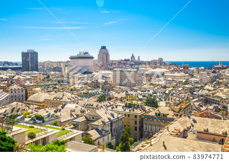 Top aerial scenic panoramic view from above of old historical centre quarter and modern districts of european city Genoa 83974771