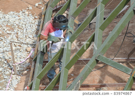 SELANGOR, MALAYSIA -DECEMBER 09, 2015: Welder wearing protective mask welding metal at the construction site.  83974867