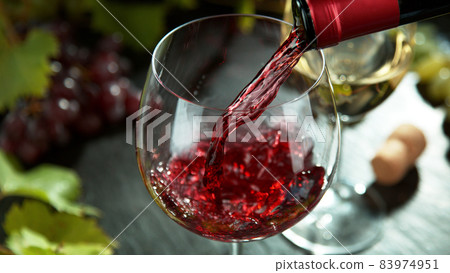 Macro shot of pouring red wine into glass. 83974951
