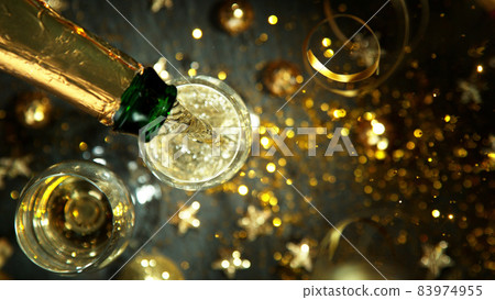 Top shot of pouring champagne wine into glass. Top shot of pouring champagne wine into glass. 83974955