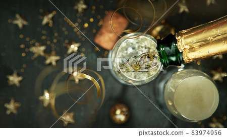 Top shot of pouring champagne wine into glass. Top shot of pouring champagne wine into glass. 83974956