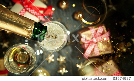 Top shot of pouring champagne wine into glass. Top shot of pouring champagne wine into glass. 83974957