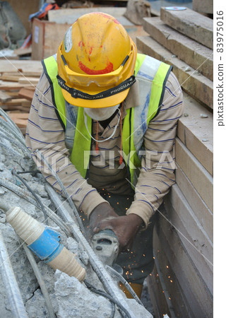 SELANGOR, MALAYSIA -MARCH 15, 2015: Construction workers cutting metal using mobile grinder at the construction site in Selangor, Malaysia.  83975016