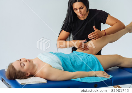 Anti-cellulite massage of hips. lymph drainage treatment. Woman receiving professional body, leg and foot massage. Wellness, healing and relaxation concept. Anti-cellulite massage of hips. lymph drainage treatment. Woman receiving professional body, leg and foot massage. Wellness, healing and relaxation concept. 83981743