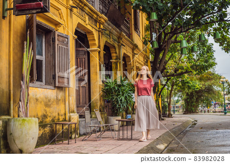 Woman tourist on background of Hoi An ancient town, Vietnam. Vietnam opens to tourists again after quarantine Coronovirus COVID 19 Woman tourist on background of Hoi An ancient town, Vietnam. Vietnam opens to tourists again after quarantine Coronovirus COVID 19 83982028