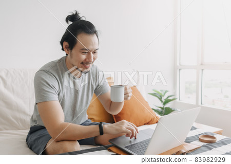 Happy creative man work on laptop in his home office apartment. 83982929