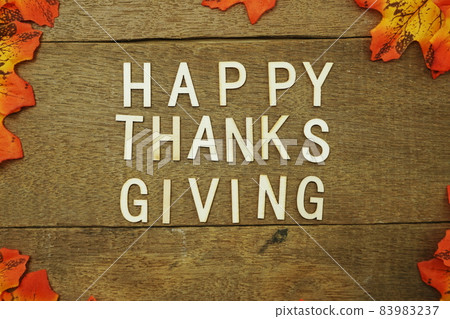 Happy Thanksgiving alphabet letters and maple leave on wooden background 83983237