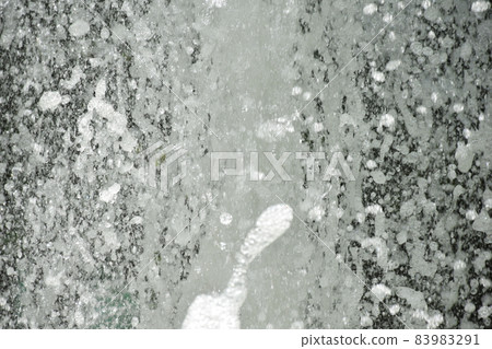 Splash of water gush of water of a fountain abstract background 83983291