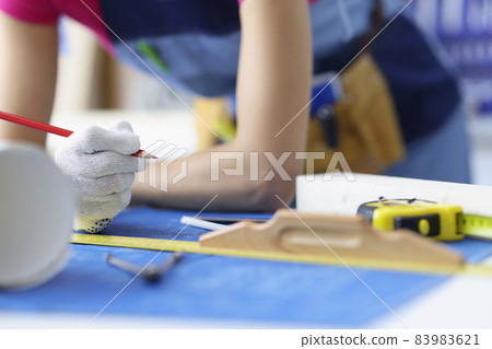 Woman worker making corrections in construction planning with pencil 83983621