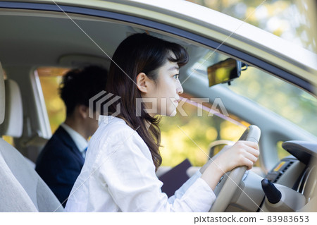 A pretty woman who goes to a driving school 83983653