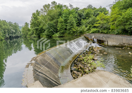 Small hydroelectric power plant in the river, France. Operating since the 60s 83983685