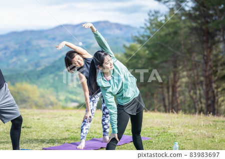 Men and women doing radio exercises outdoors Men and women doing radio exercises outdoors 83983697