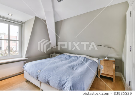 Bedroom with a large soft bed and a window 83985529